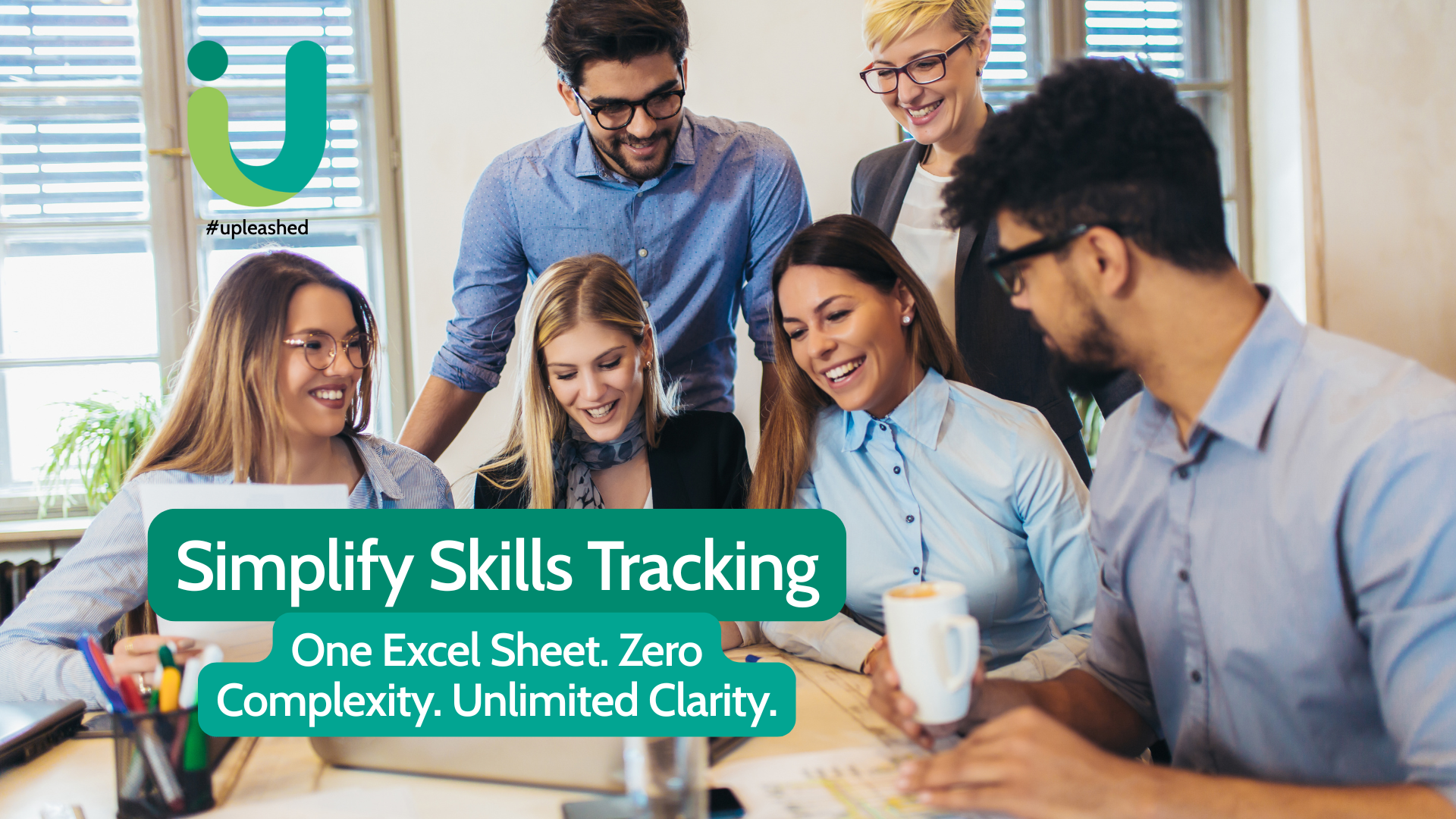 A diverse team of professionals smiling and collaborating around a laptop, representing easy skills tracking with Upleashed’s one-page Excel Skills Matrix.